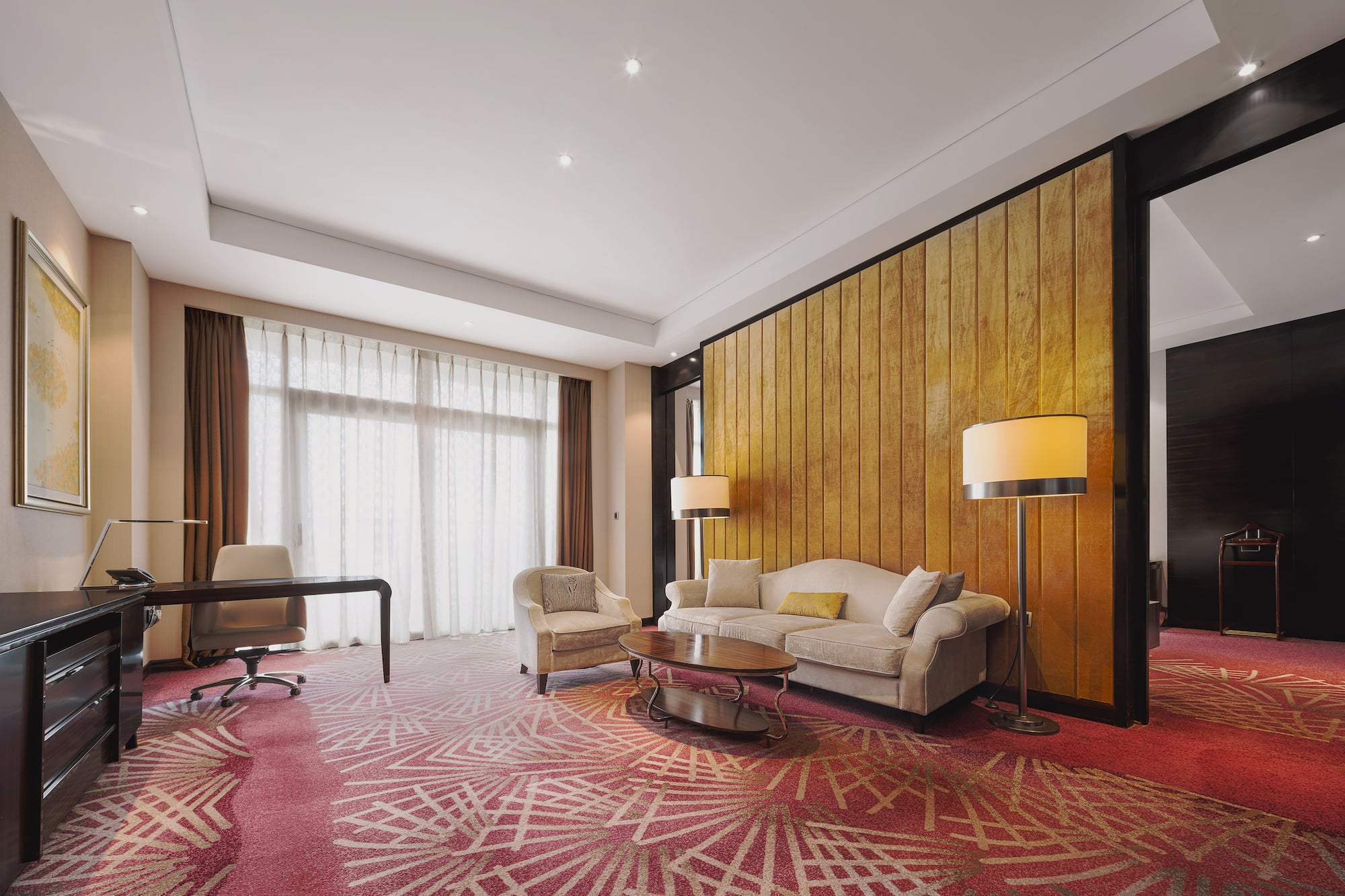 a room with a couch and chairs