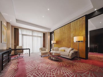 a room with a couch and chairs