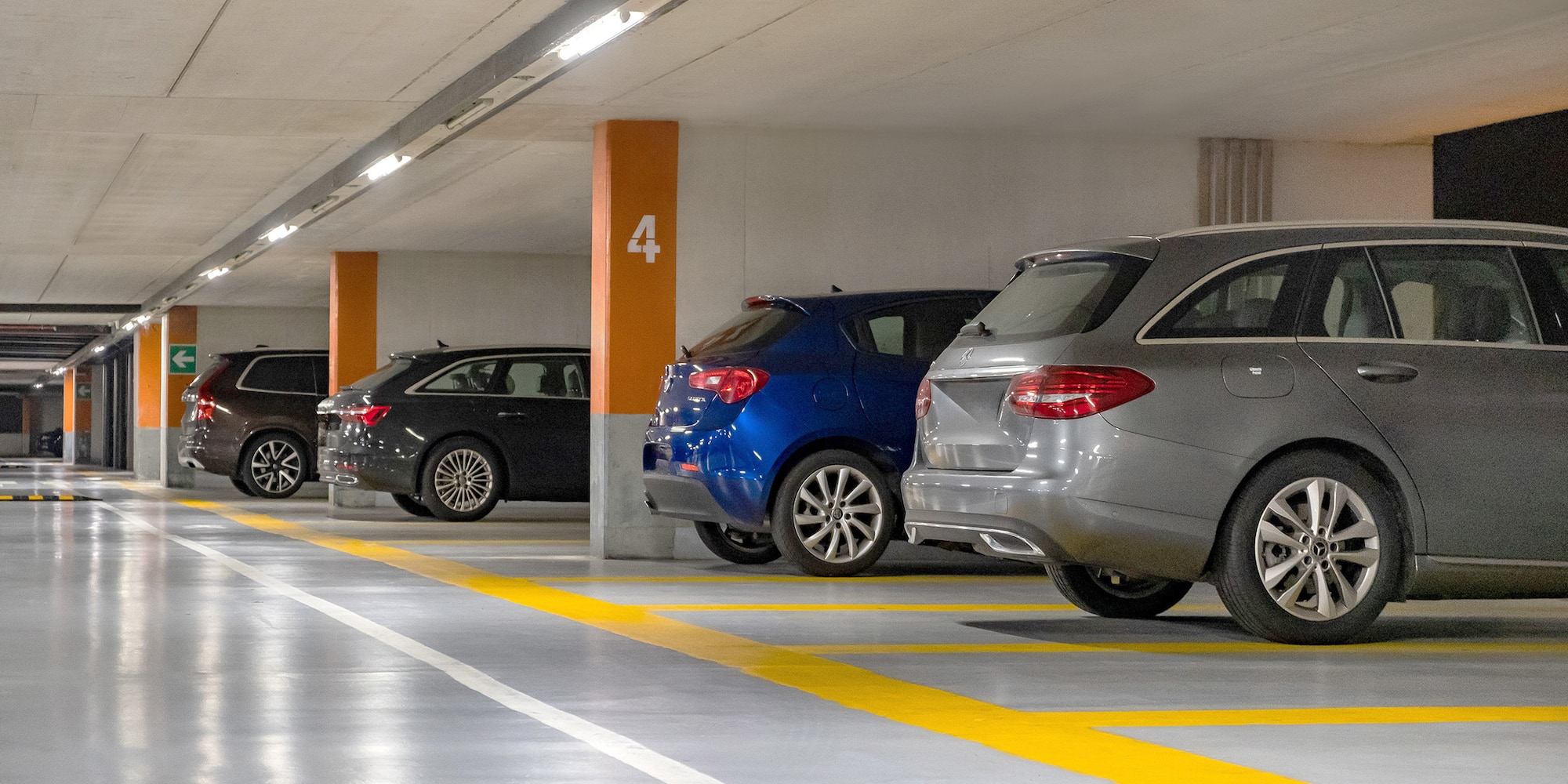 a group of cars parked in a parking garage