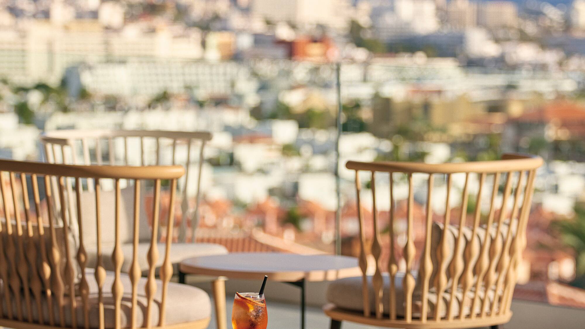 a table with chairs and a drink on it
