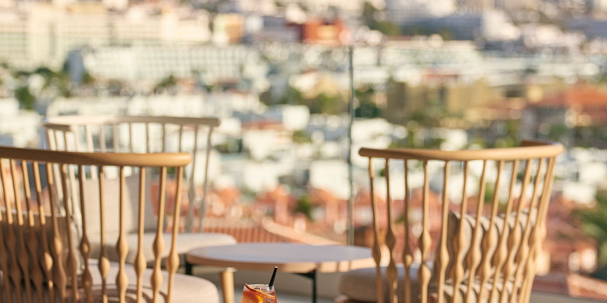 a table with chairs and a drink on it