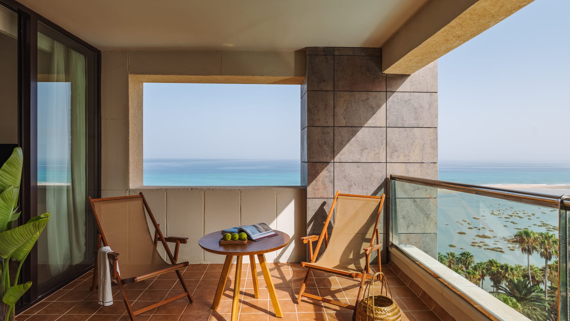 a deck with chairs and a table on a tile floor