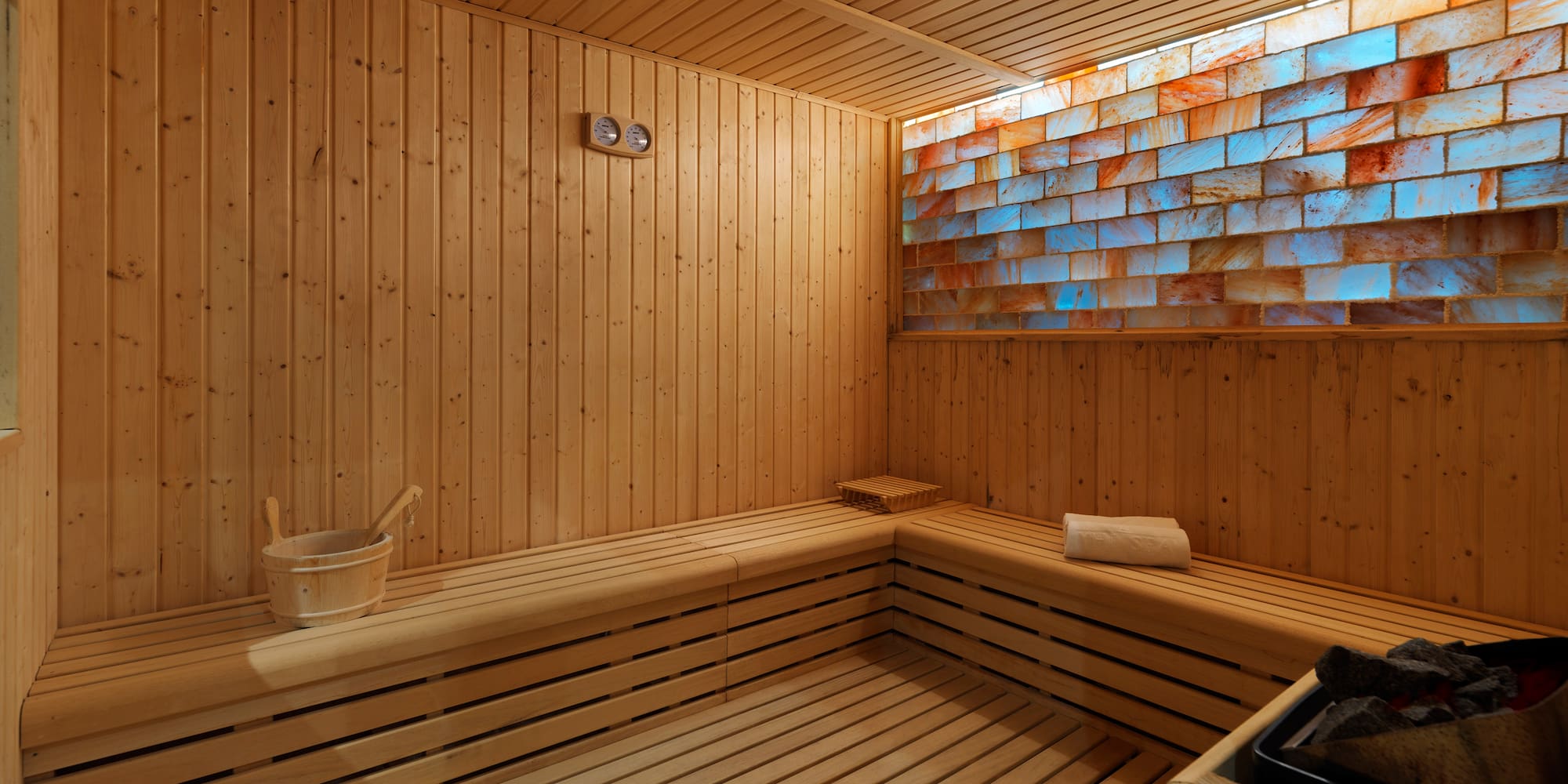 a wooden sauna with a bucket and a bucket