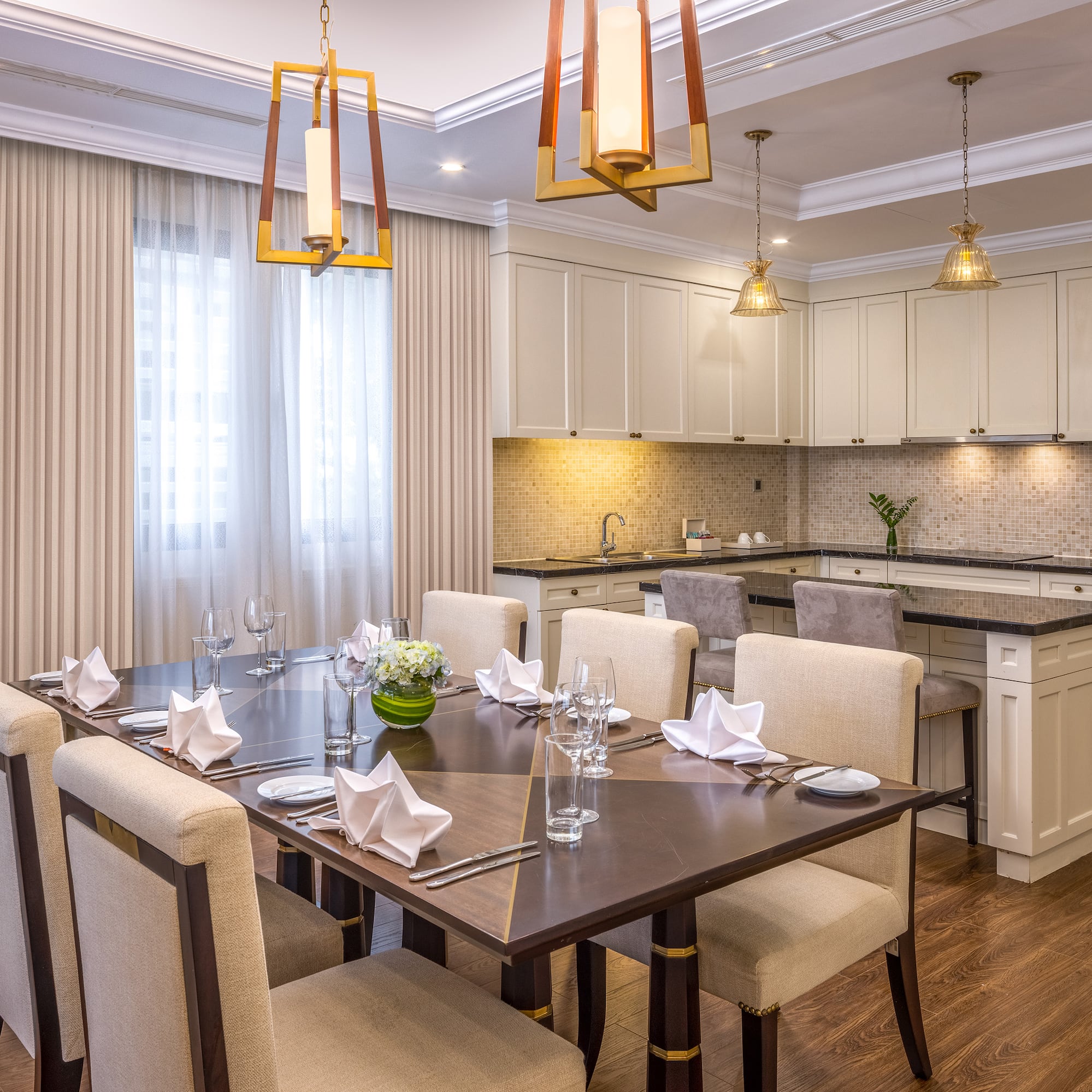 a dining room with a kitchen and a table