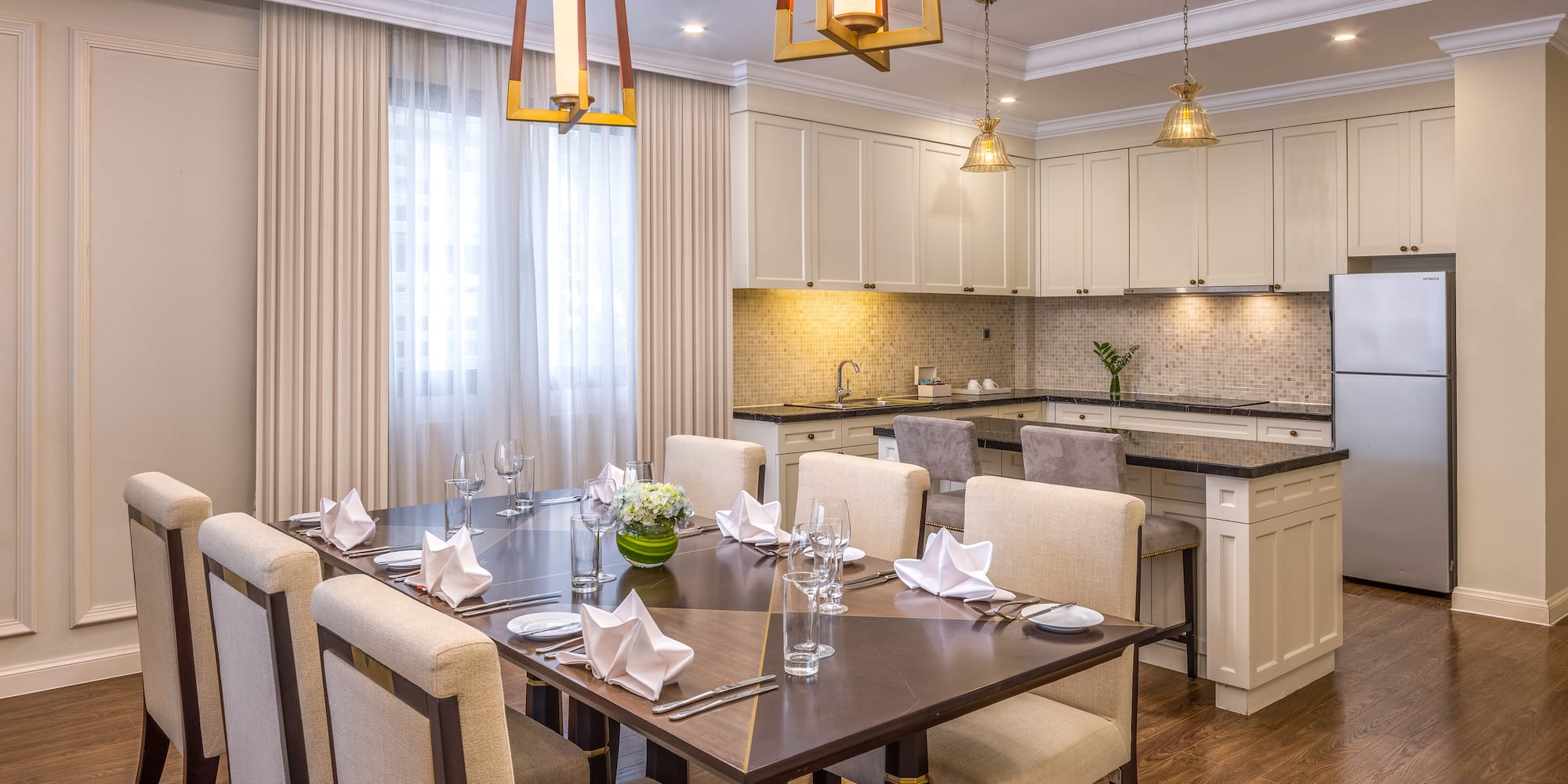 a dining room with a kitchen and a table