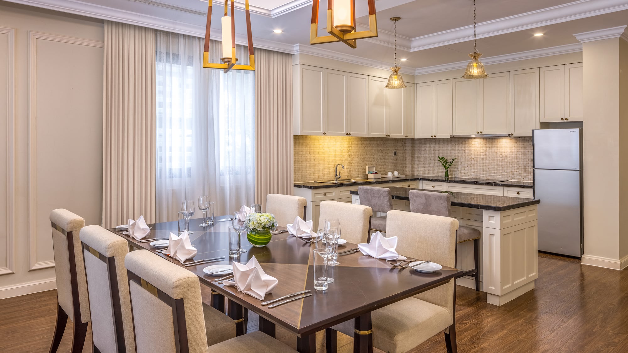 a dining room with a kitchen and a table