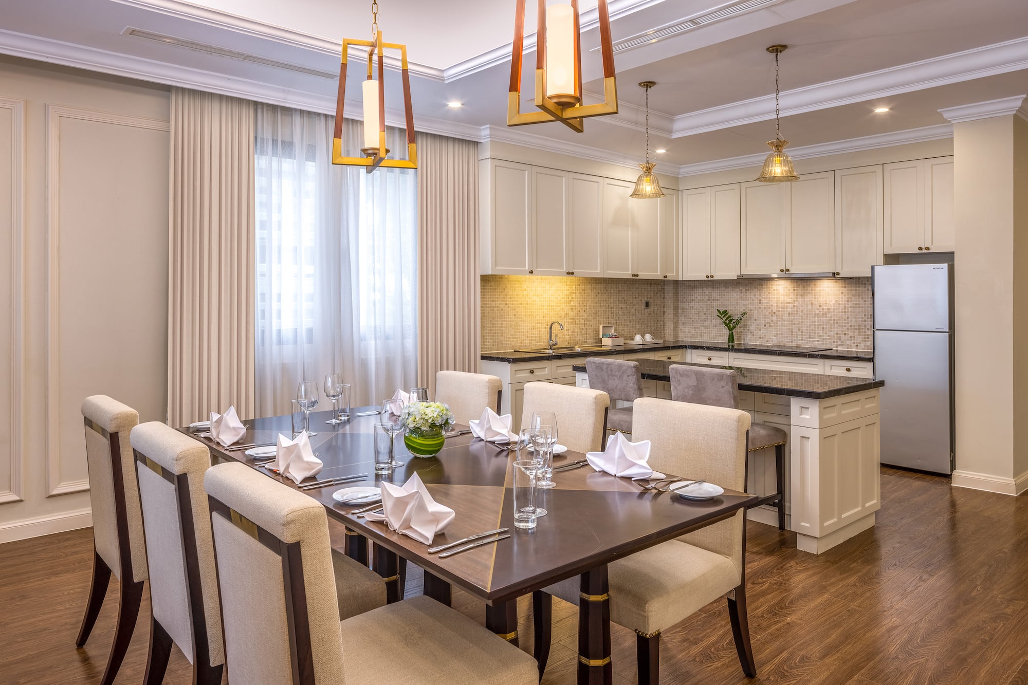 a dining room with a kitchen and a table