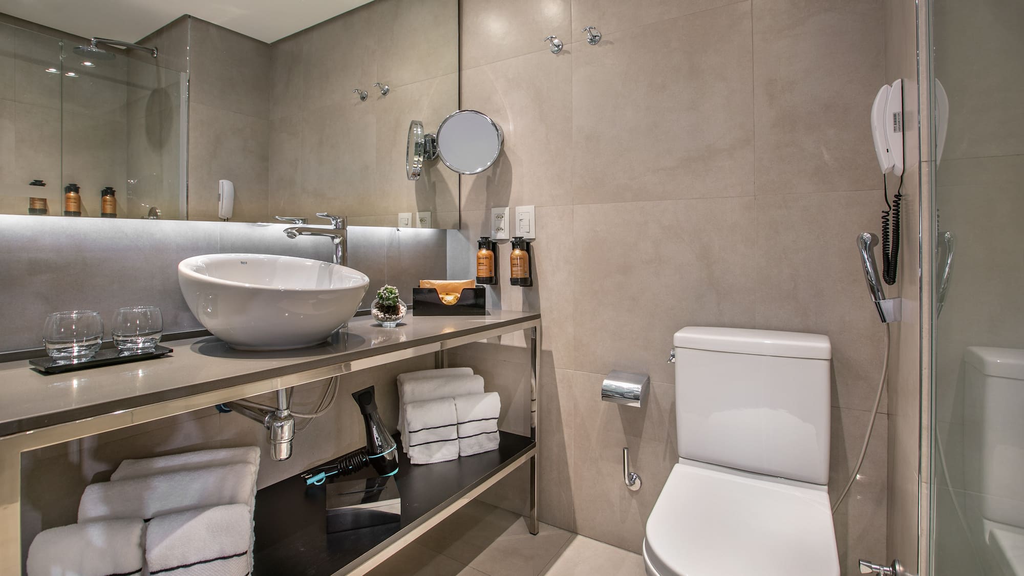 Banheiro de hotel moderno com pia de cuba e vaso sanitário. - Grand Premium - Meliá Ibirapuera, São Paulo