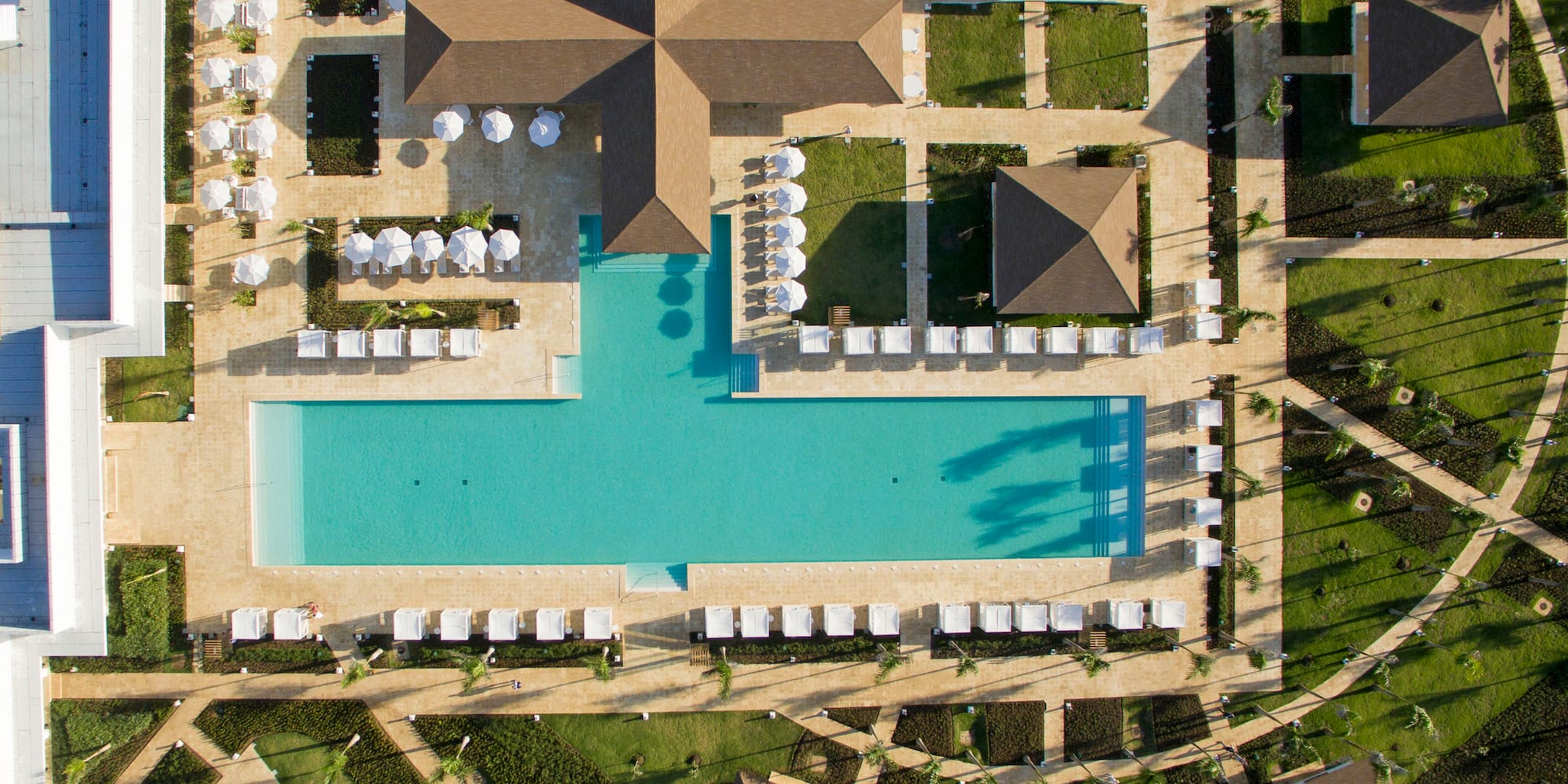 an aerial view of a resort with a pool and lawns