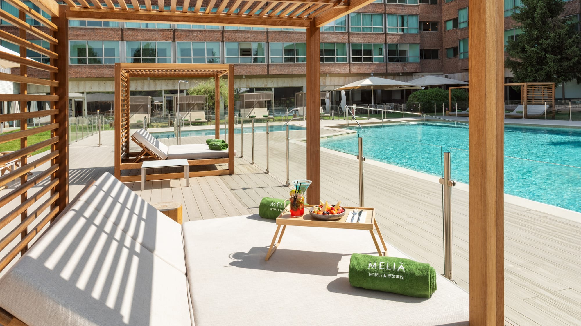 a pool with a lounge chair and a tray of food