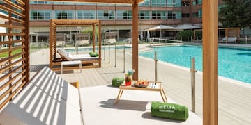 a pool with a lounge chair and a tray of food
