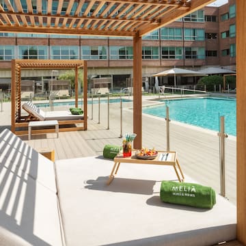 a pool with a lounge chair and a tray of food