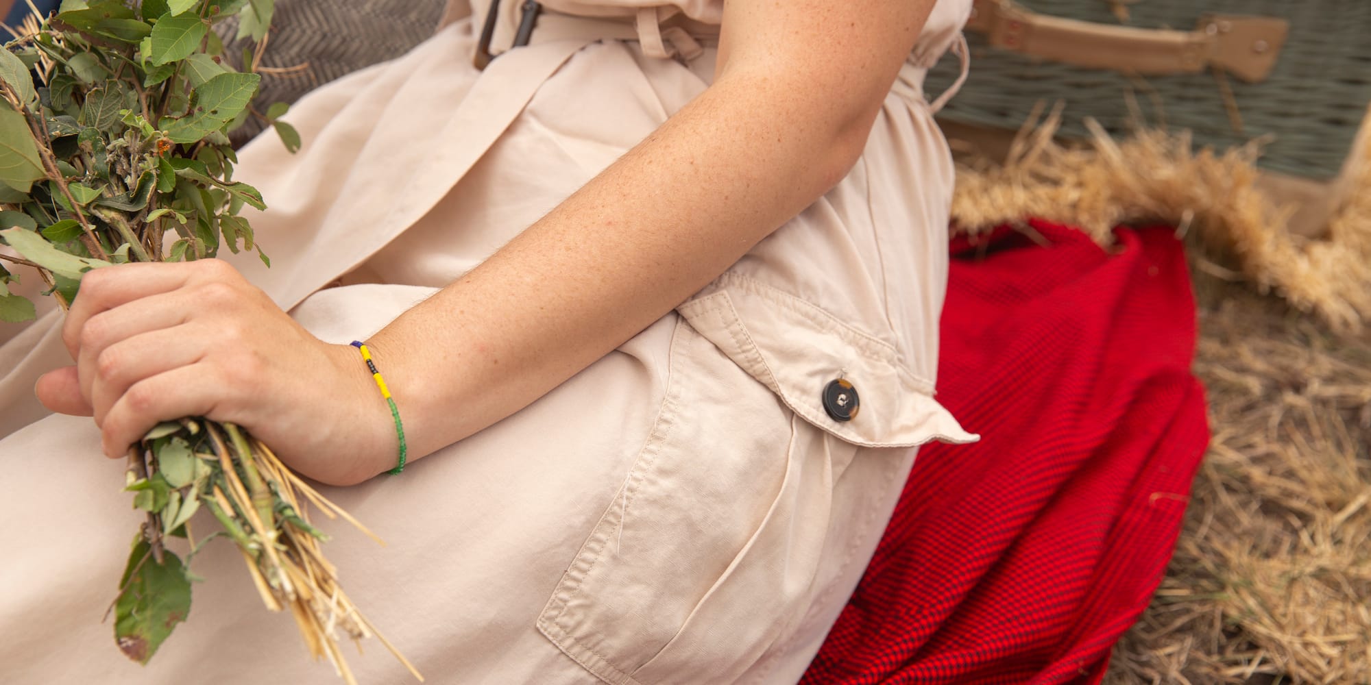 a person sitting on a blanket holding a plant