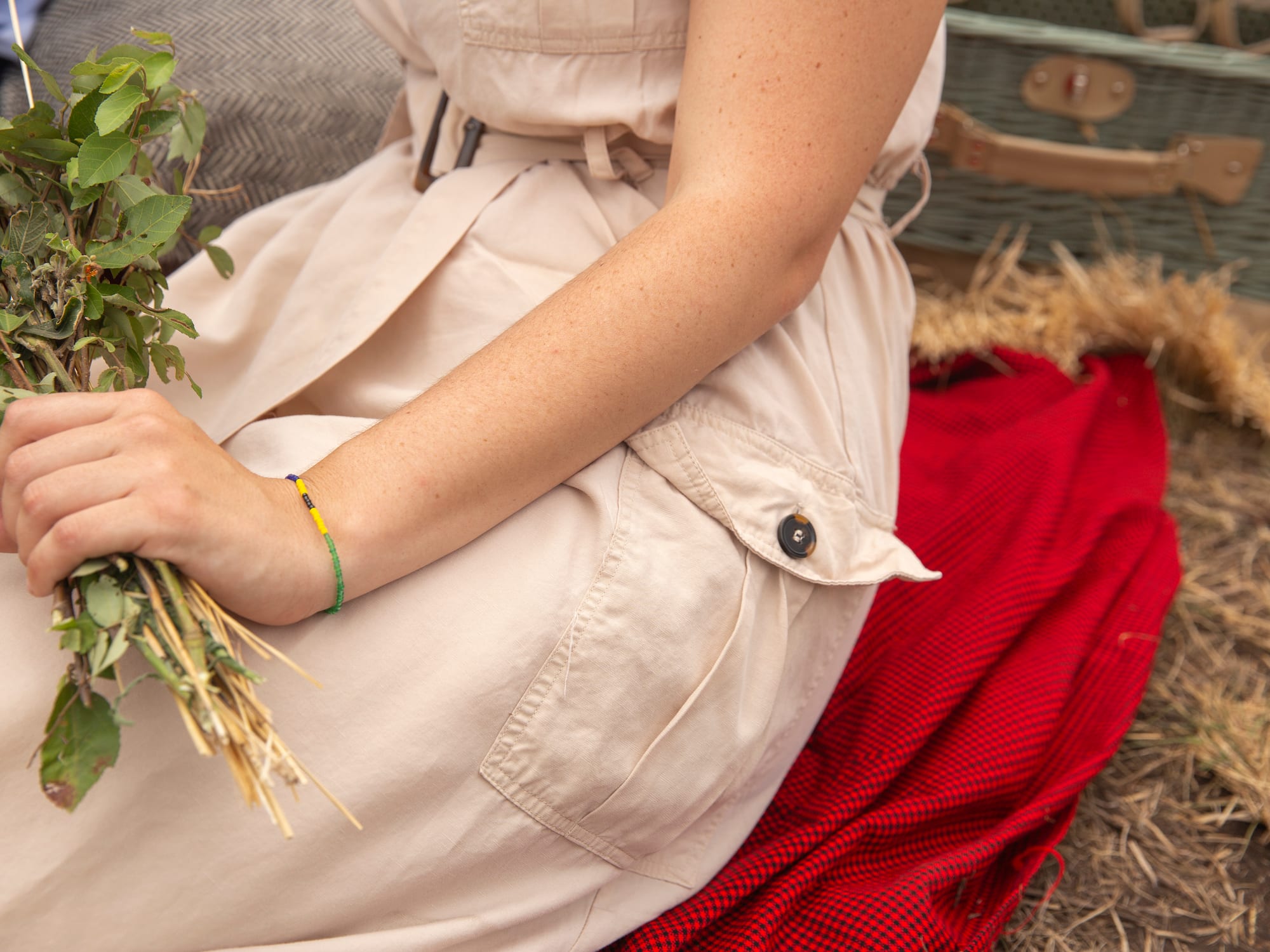 a person sitting on a blanket holding a plant