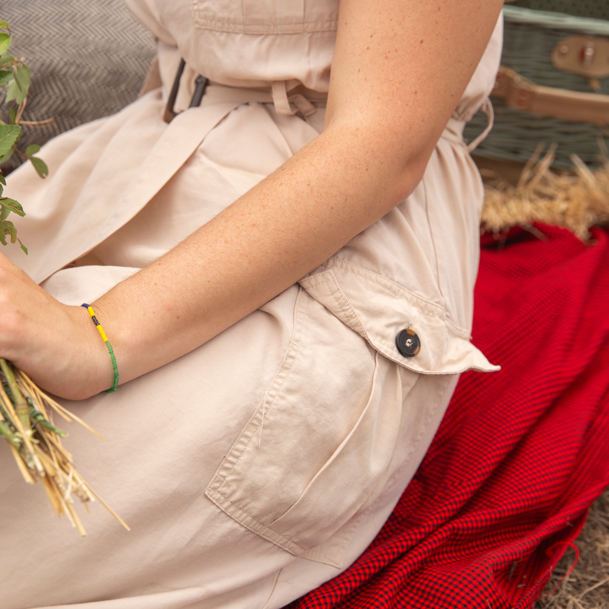 a person sitting on a blanket holding a plant