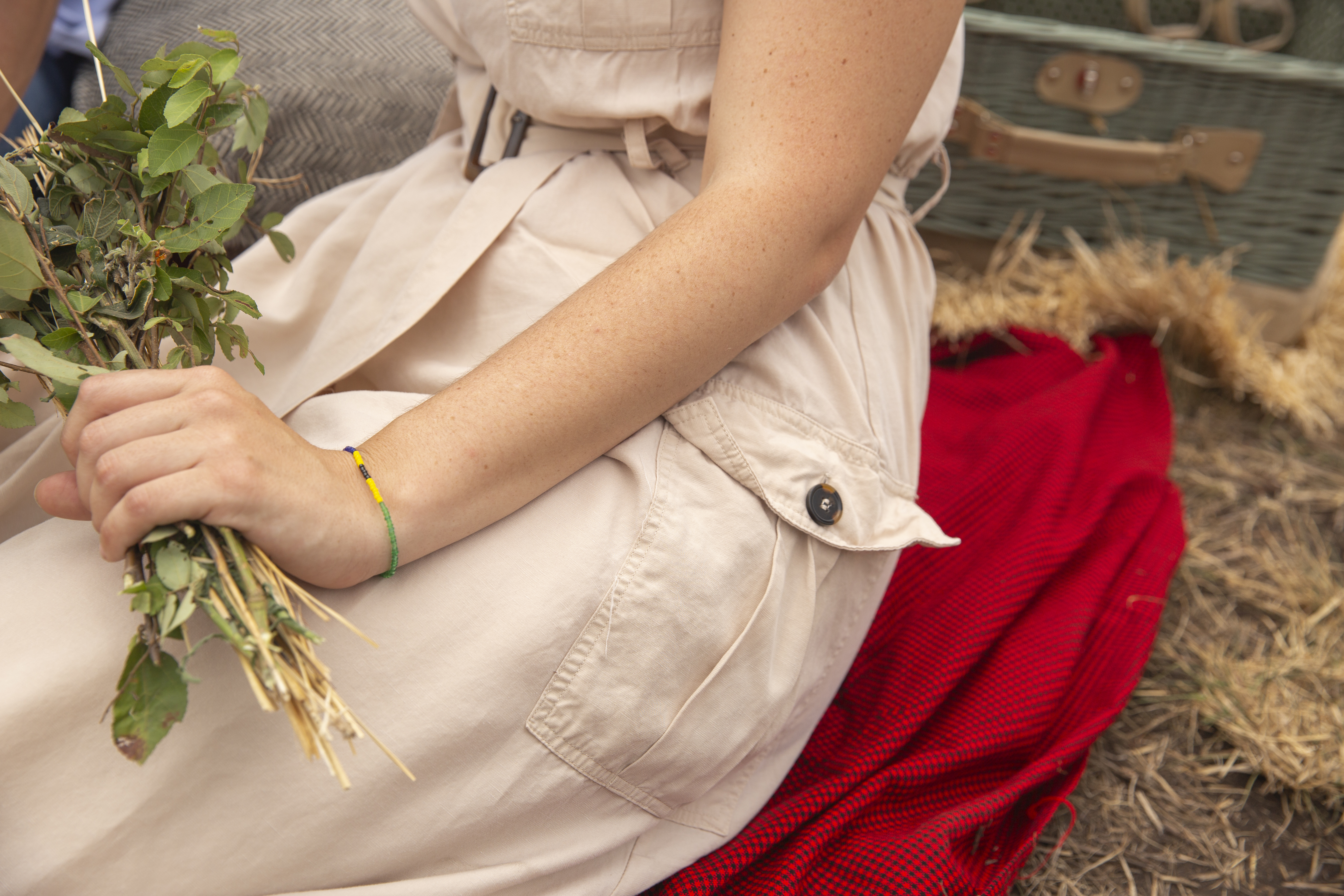 a person sitting on a blanket holding a plant