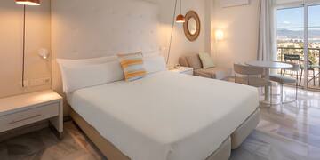 a bedroom with a bed and a table