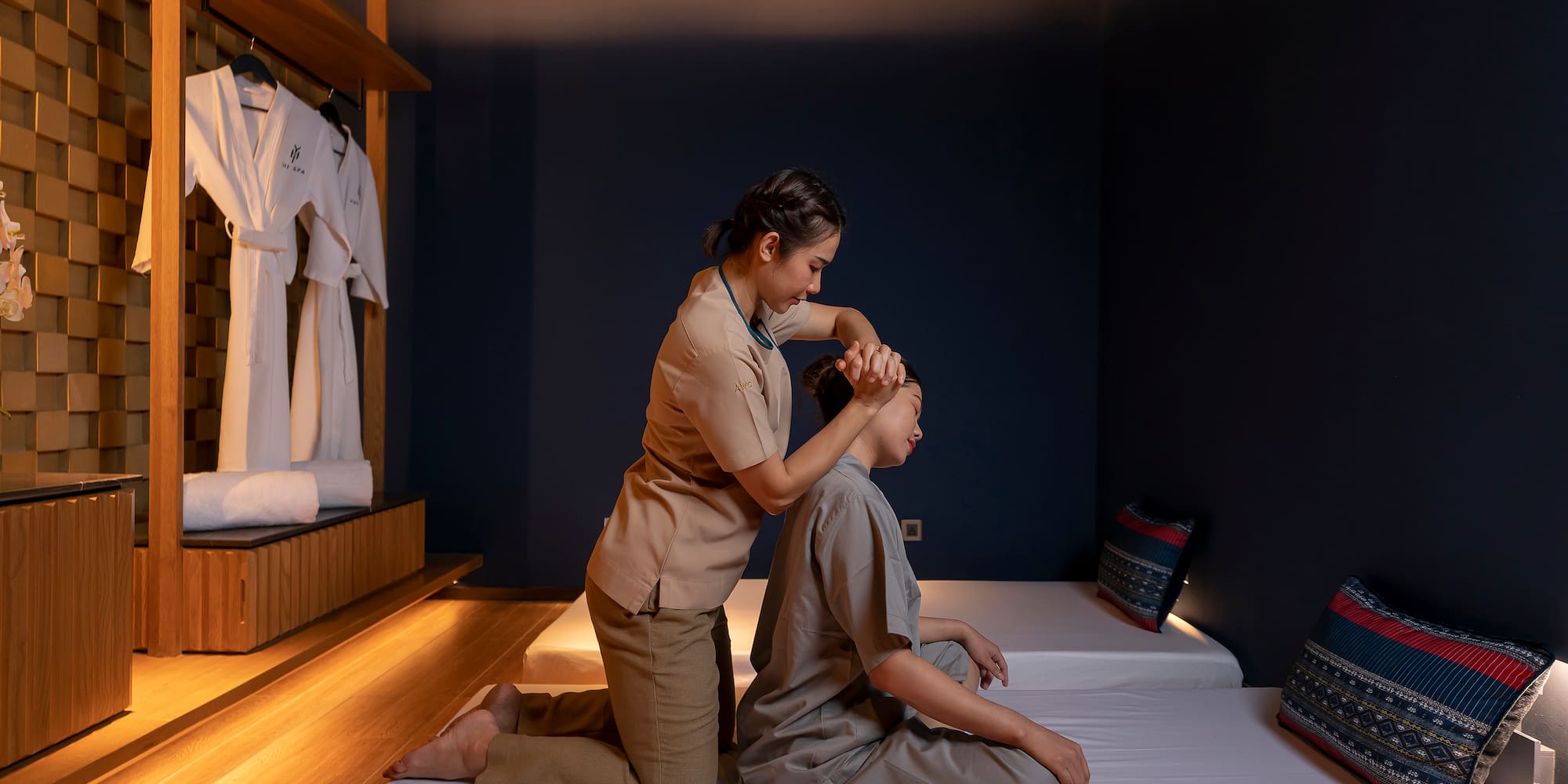 a woman massaging another woman's head