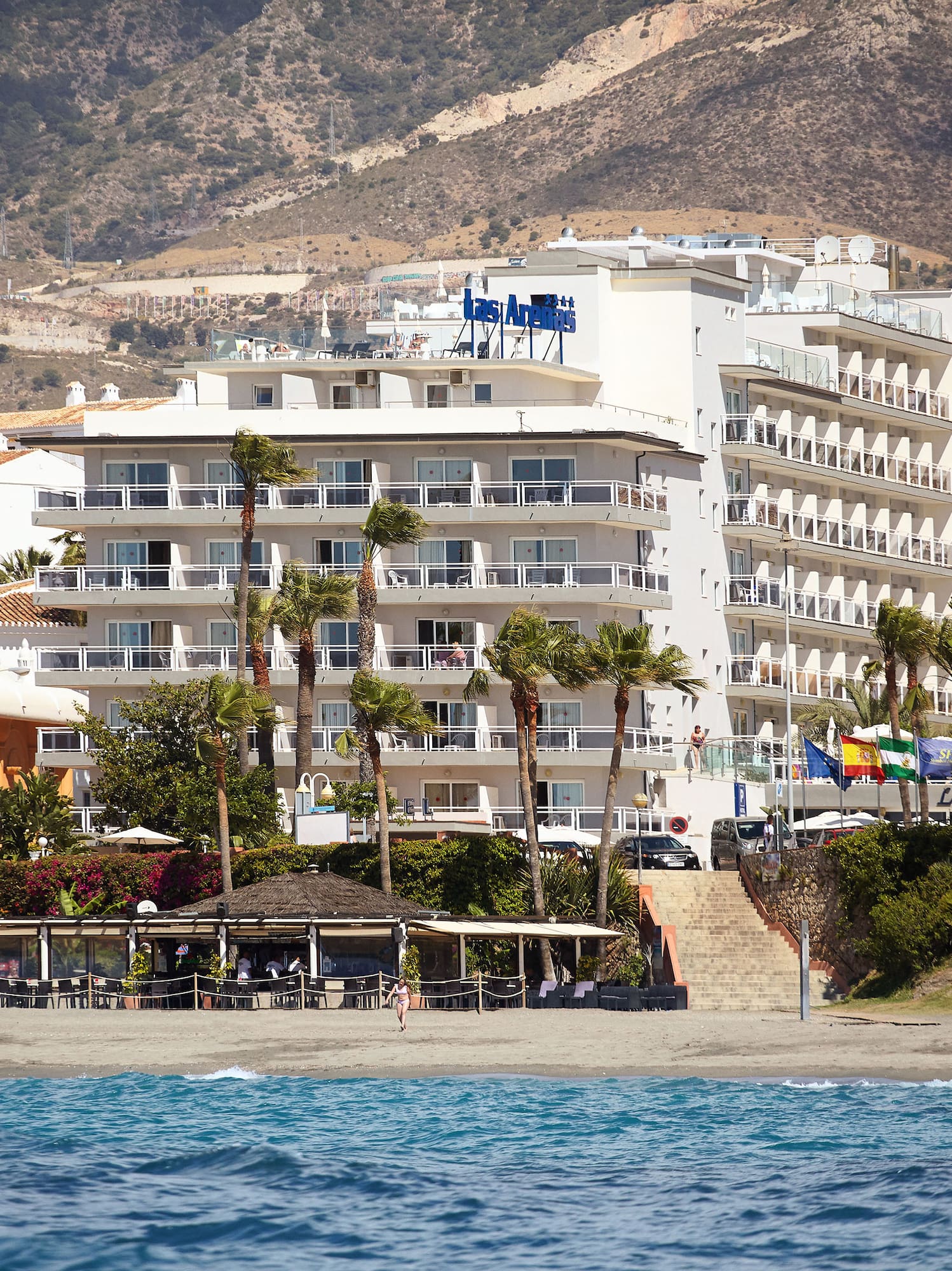 a beach with buildings and trees