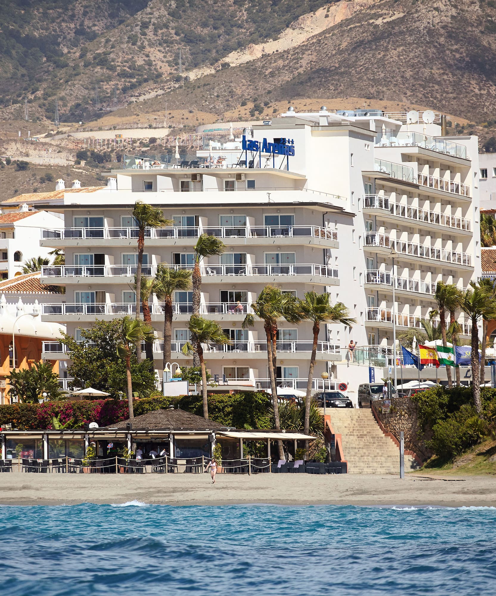 a beach with buildings and trees