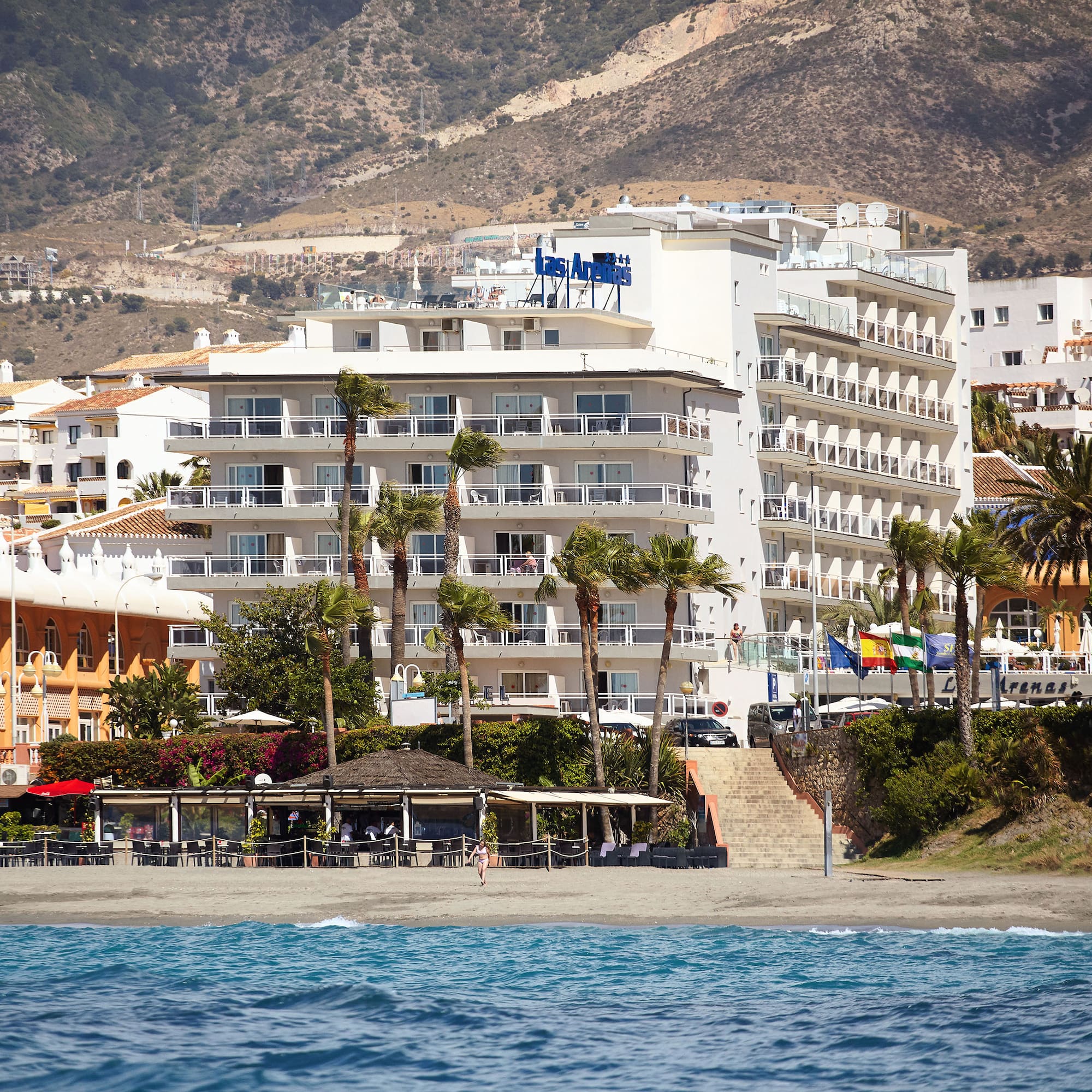 a beach with buildings and trees