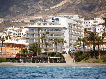 a beach with buildings and trees