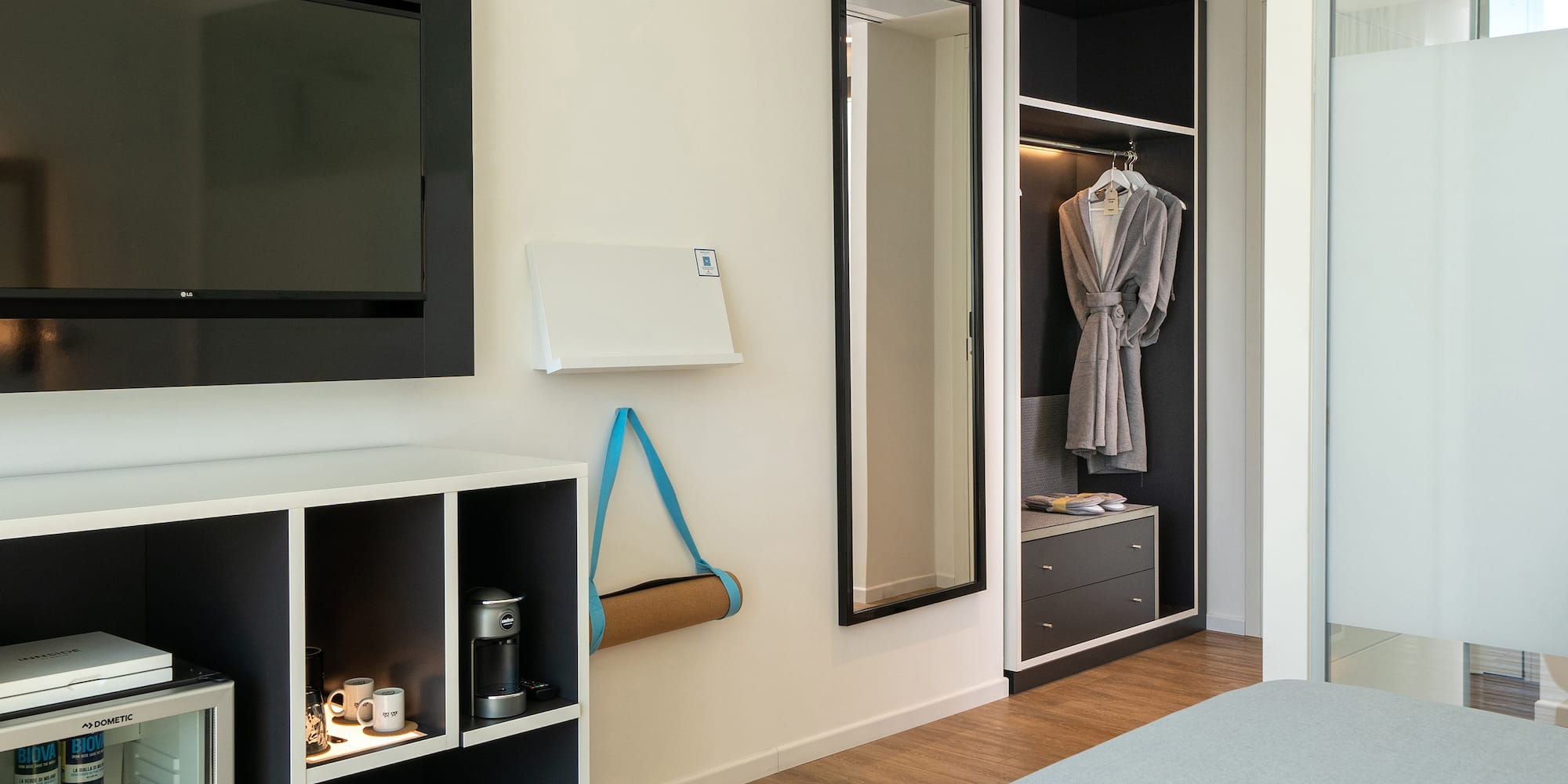 a room with a tv and a mirror