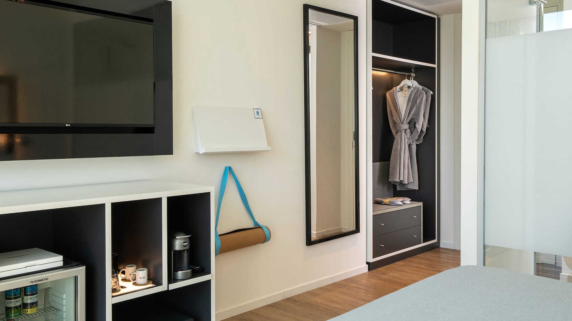 a room with a tv and a mirror