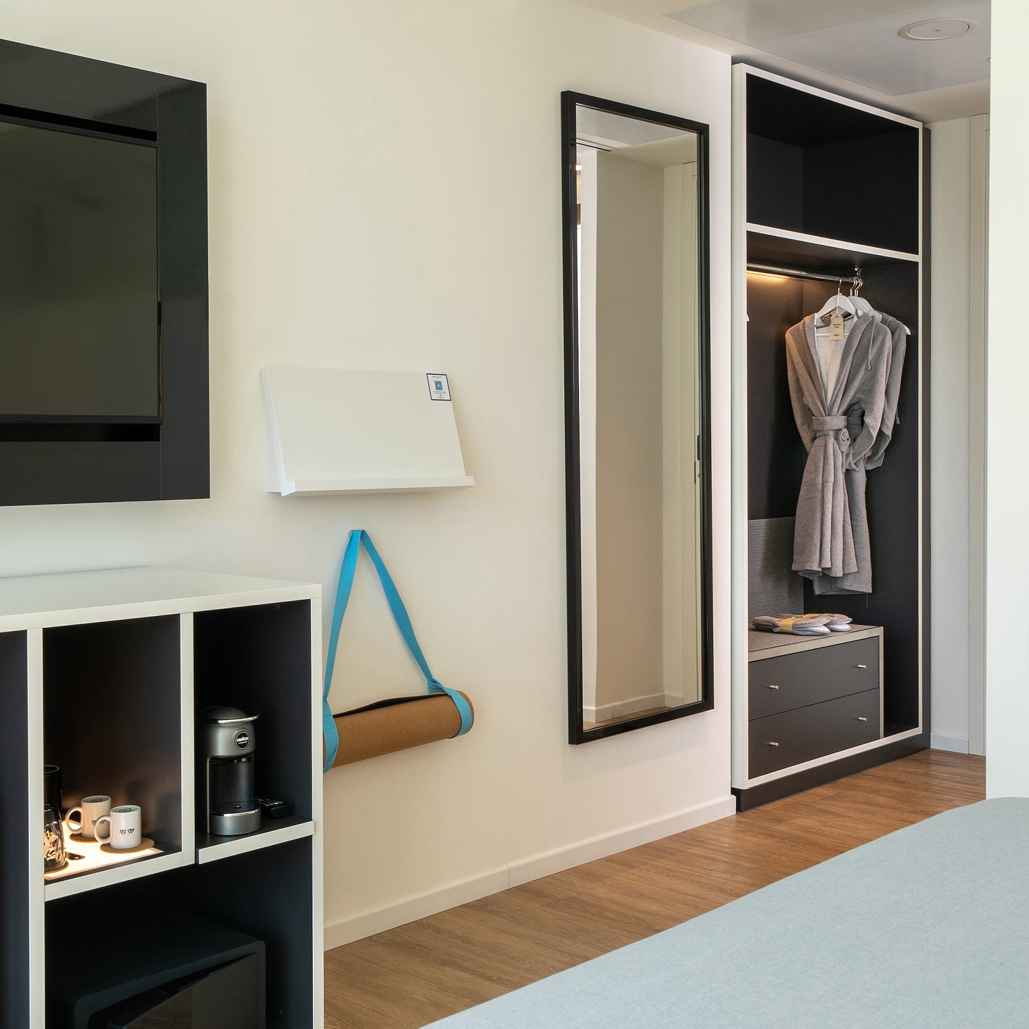 a room with a tv and a mirror