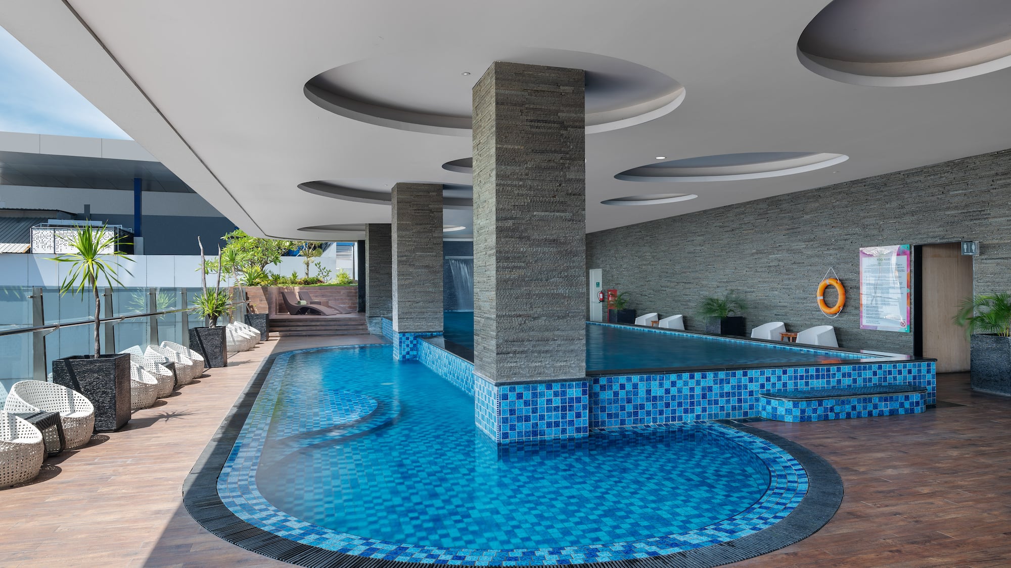 a pool with a stone wall and a stone wall