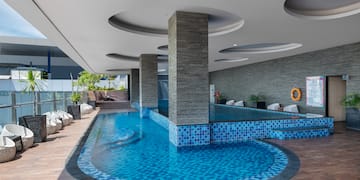 a pool with a stone wall and a stone wall