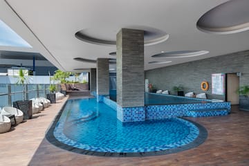 a pool with a stone wall and a stone wall