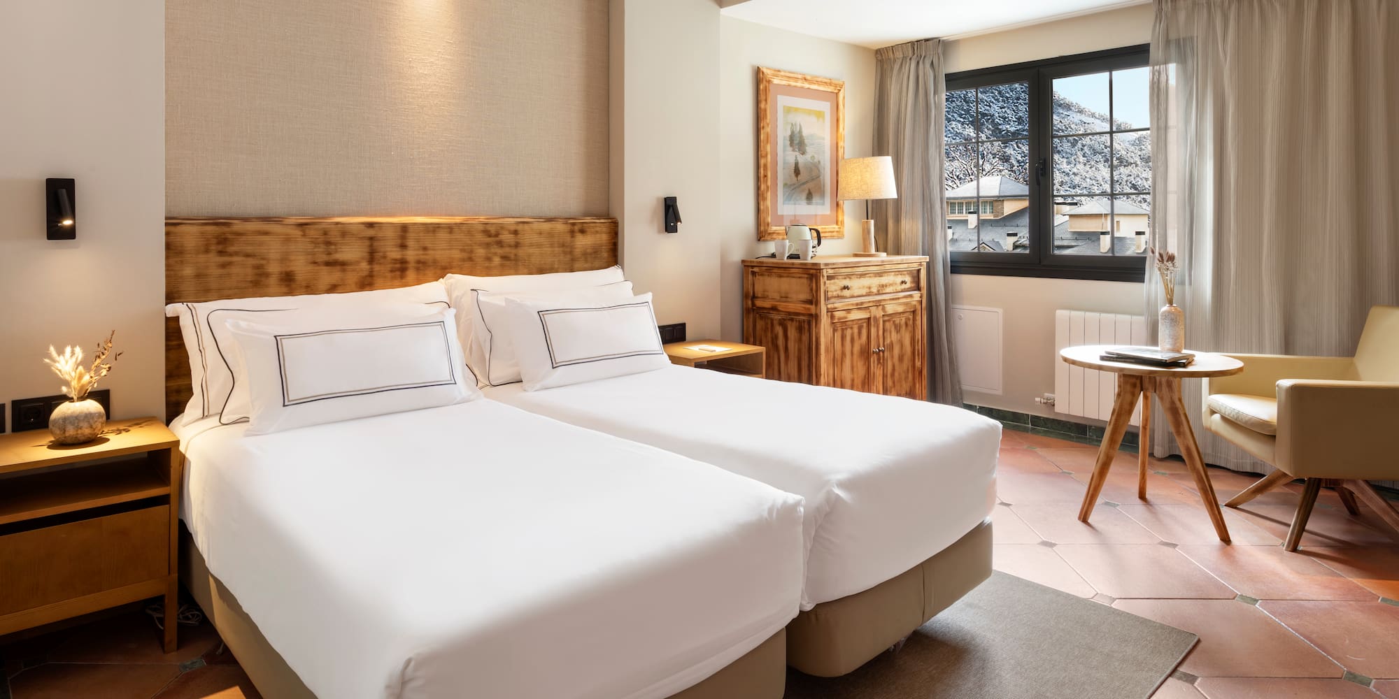 a bedroom with two beds and a table