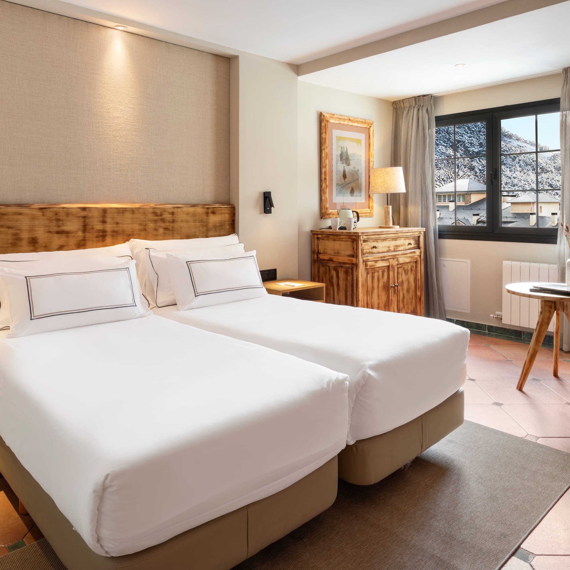 a bedroom with two beds and a table