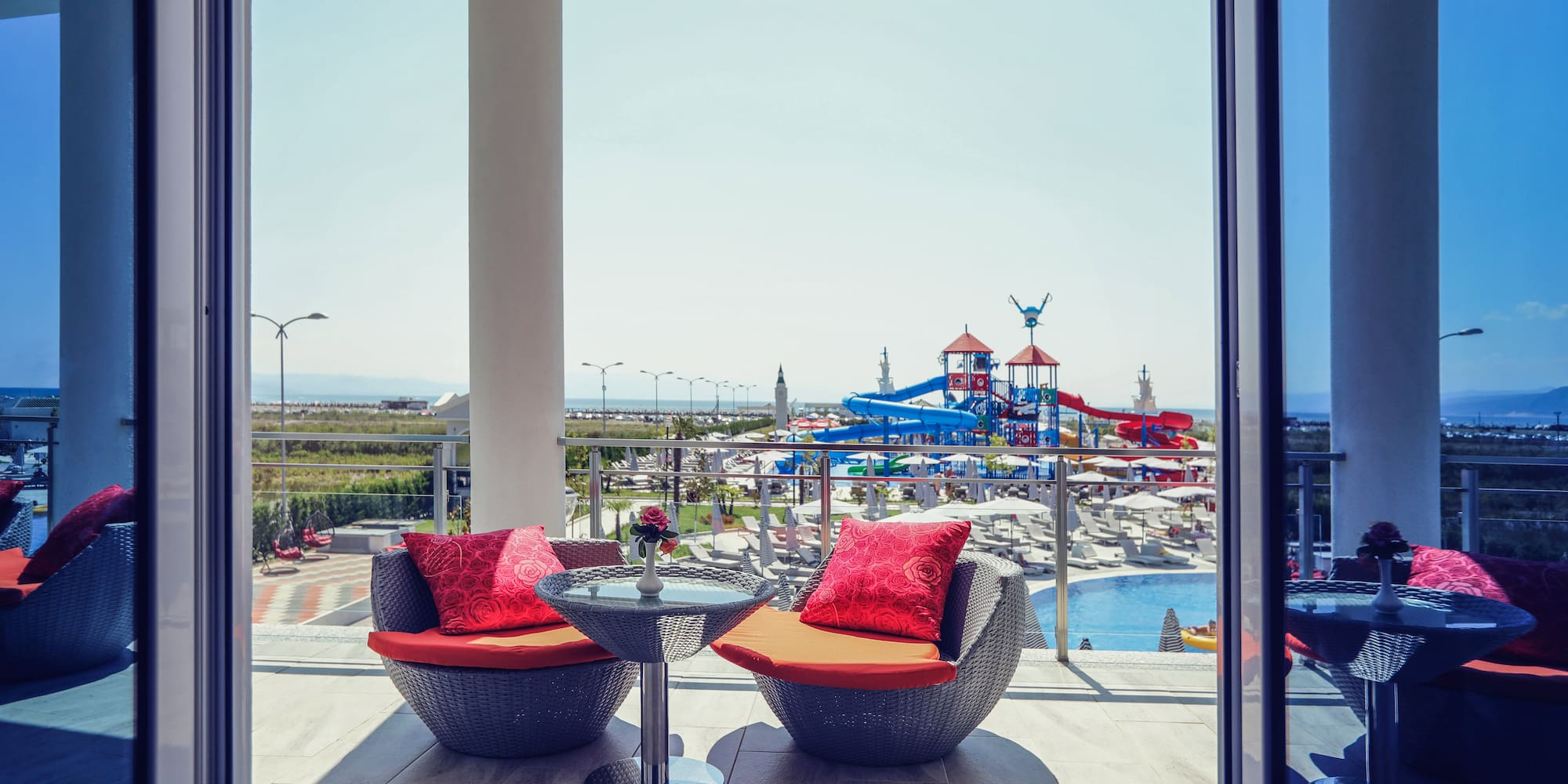 a patio with chairs and a table and a slide