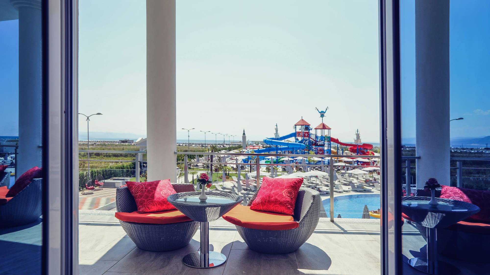 a patio with chairs and a table and a slide