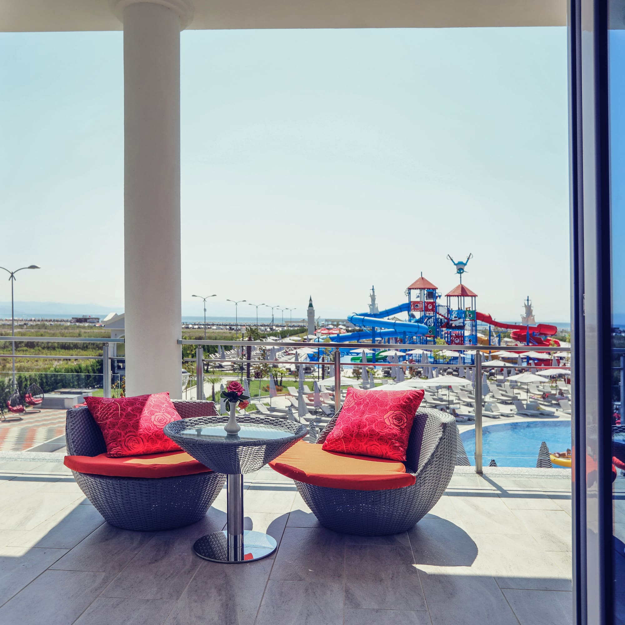 a patio with chairs and a table and a slide