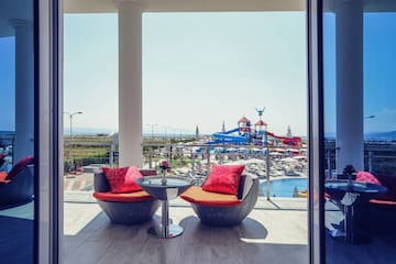 a patio with chairs and a table and a slide