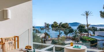 a room with a view of the ocean and a beach