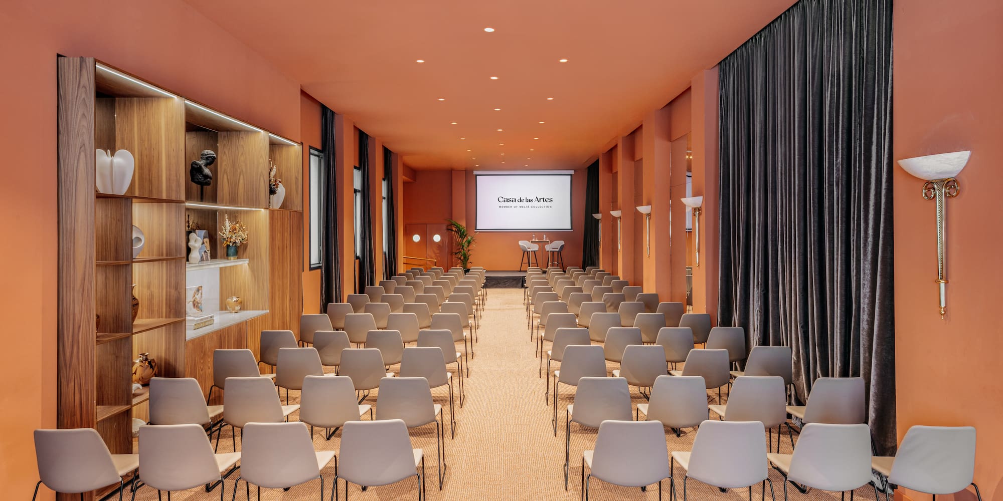 a room with chairs and a projector screen