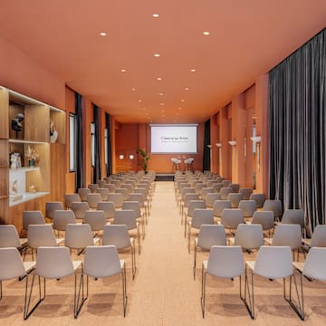 a room with chairs and a projector screen
