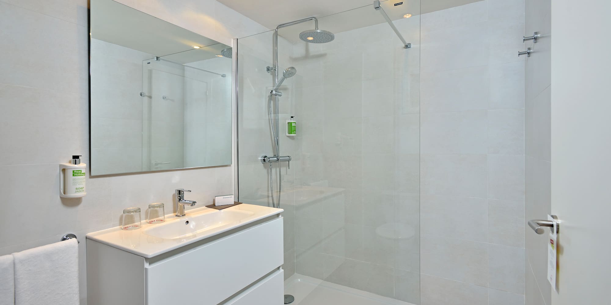 a bathroom with a shower and sink