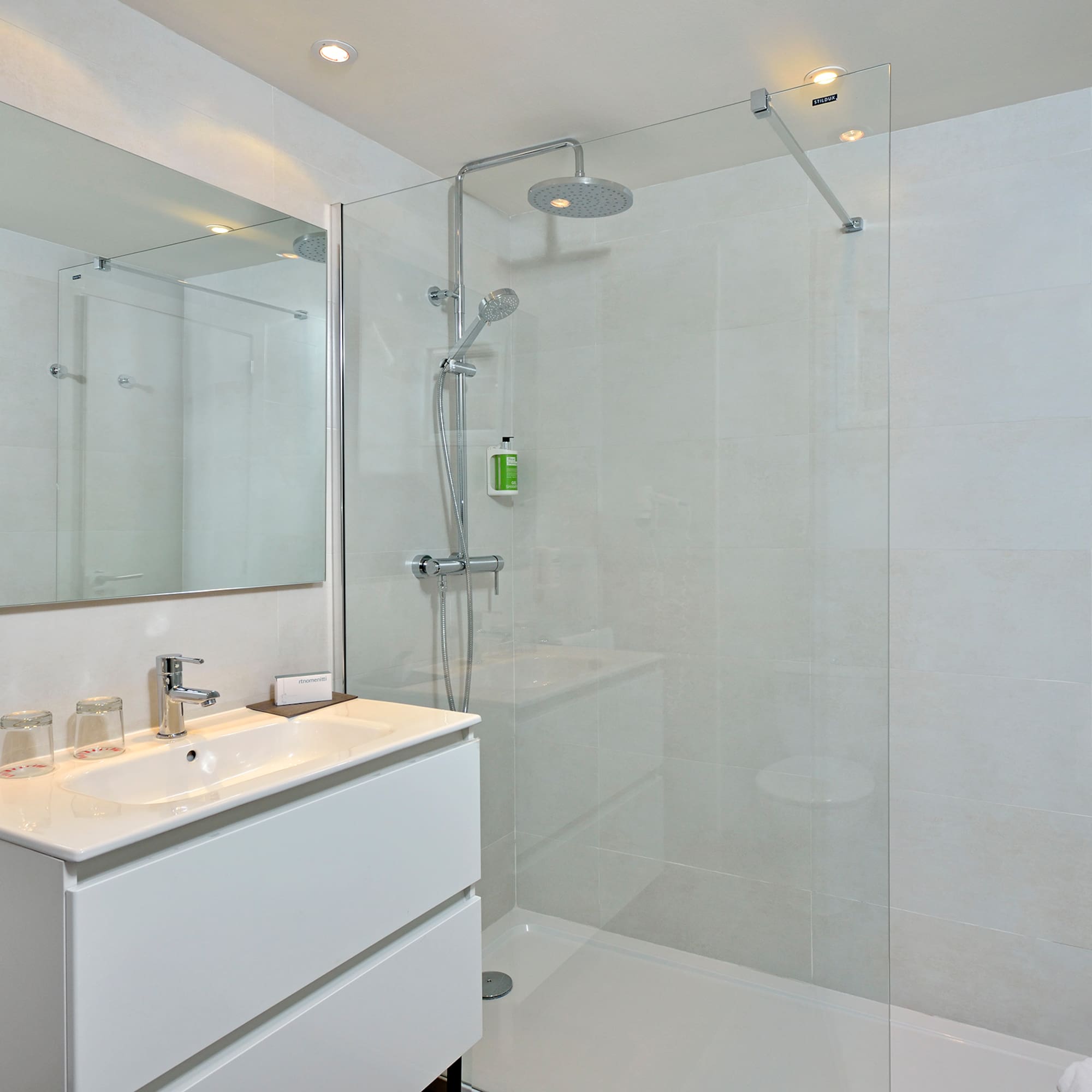 a bathroom with a shower and sink