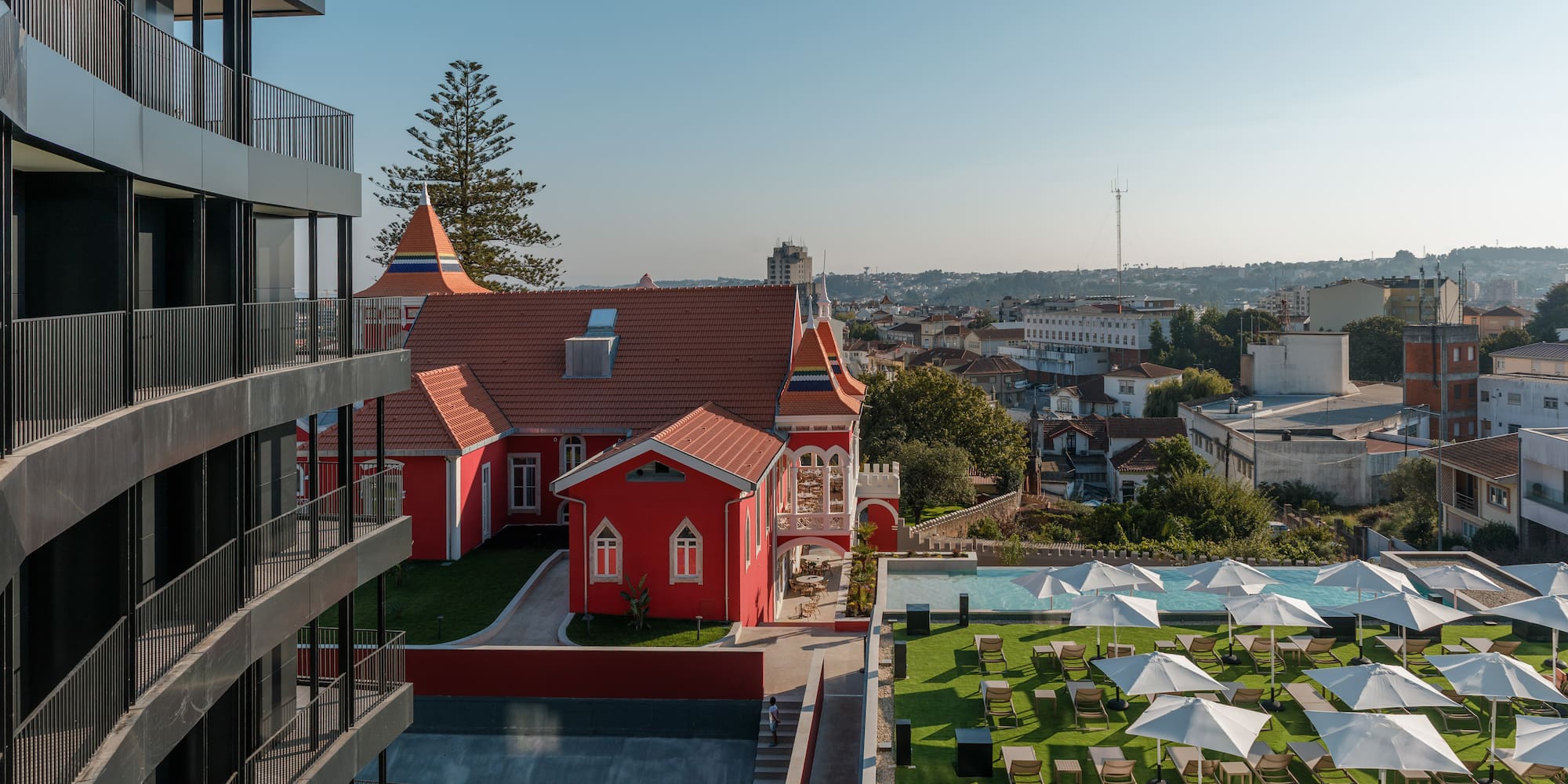 a building with a lawn and chairs