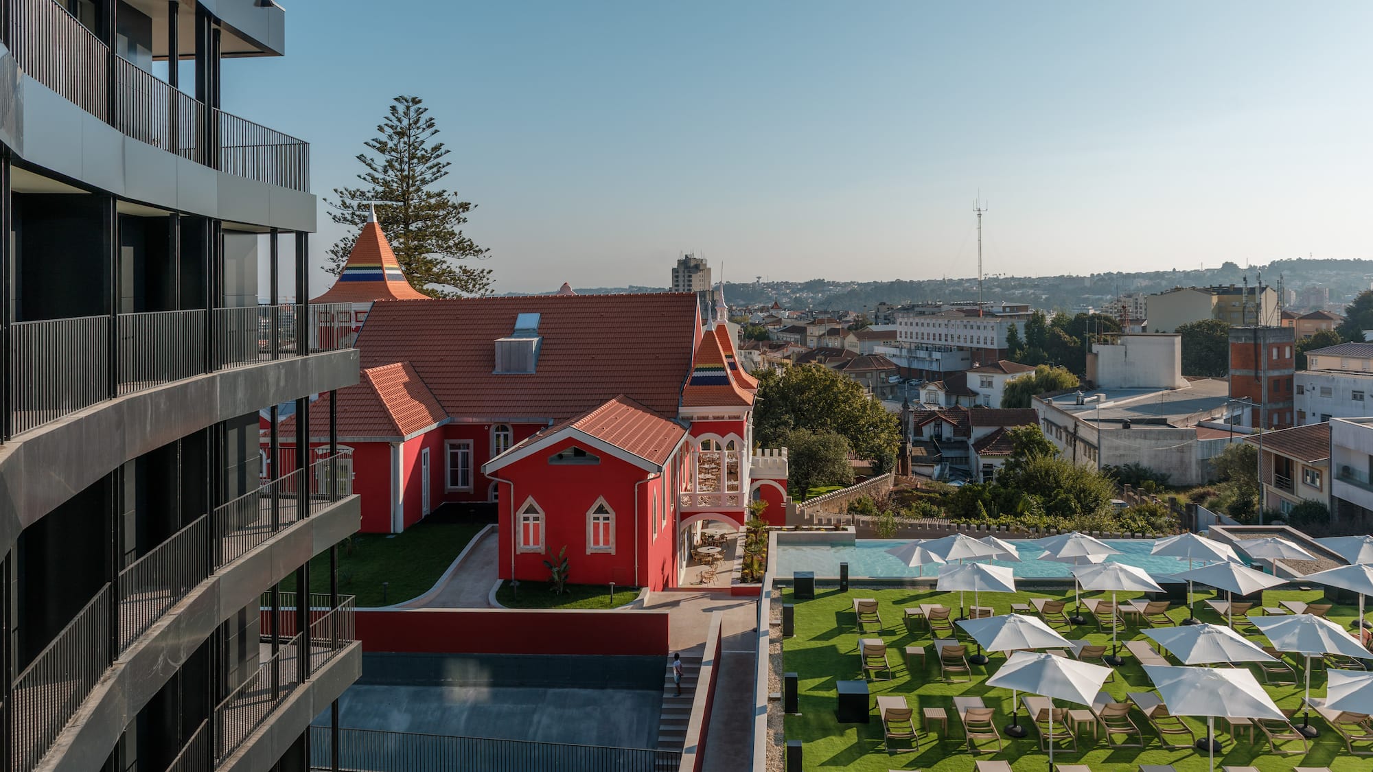 a building with a lawn and chairs