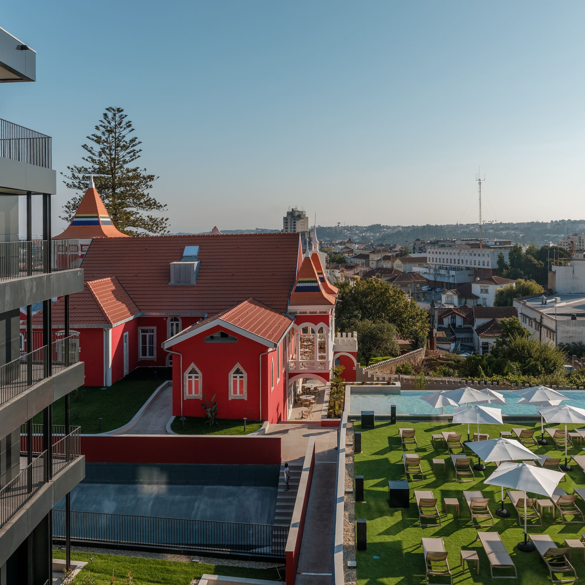 a building with a lawn and chairs