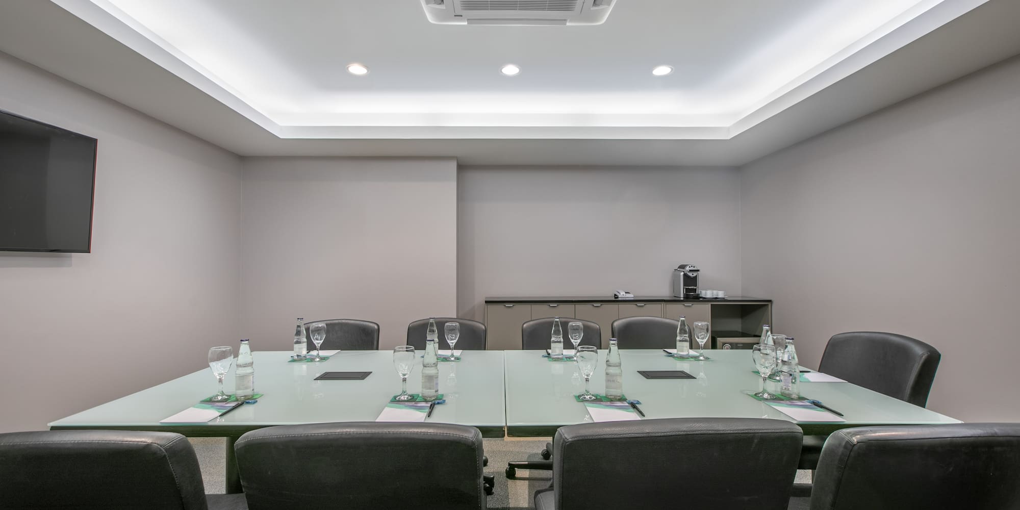a conference room with a table and chairs