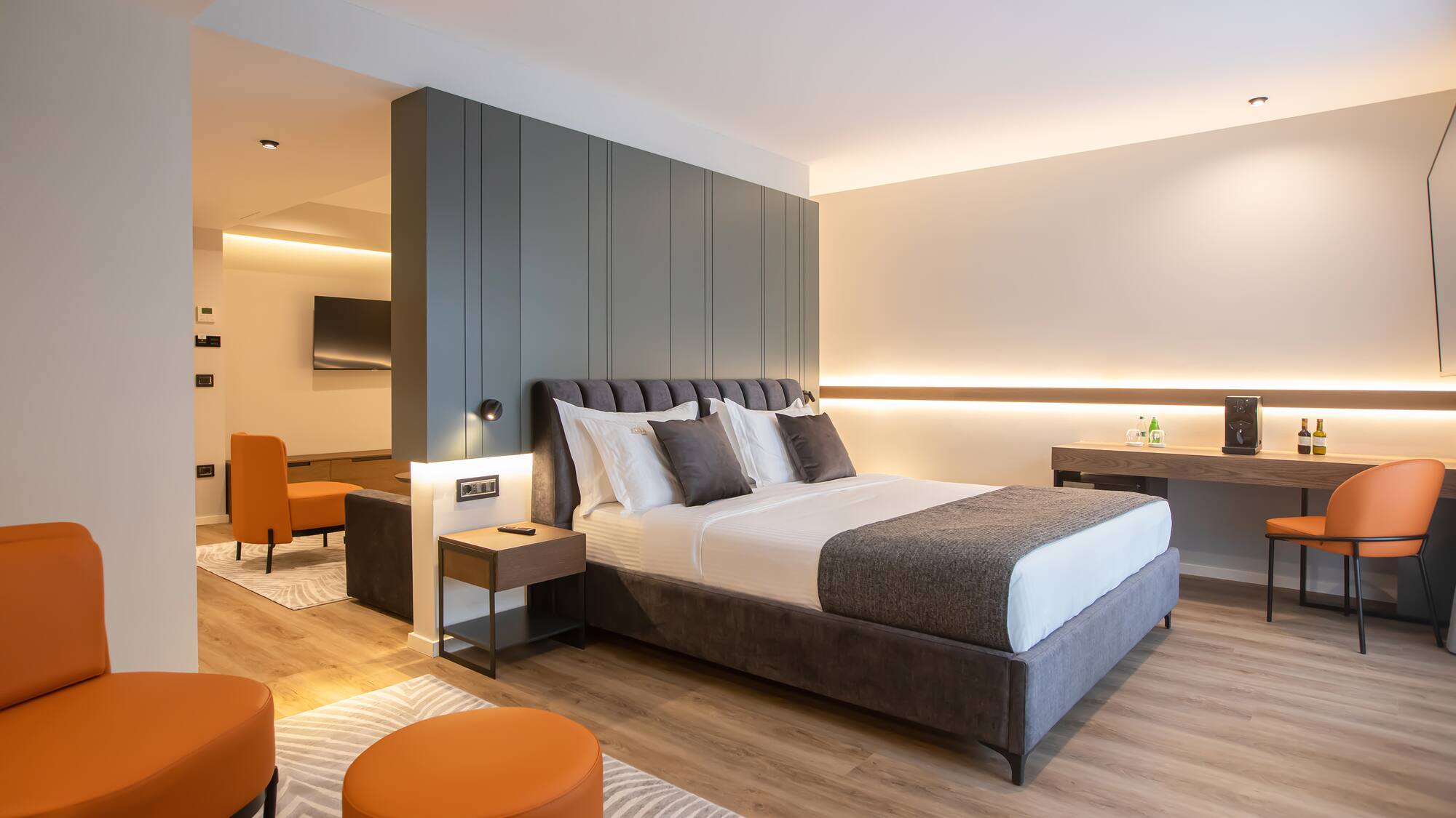 a bedroom with a bed and orange chairs