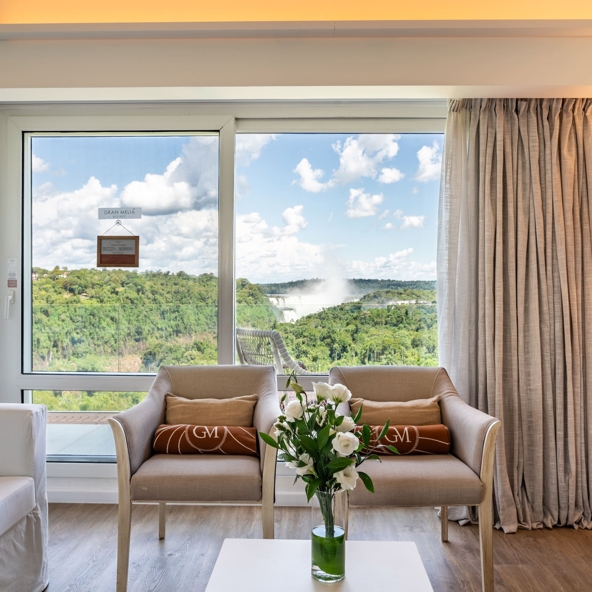 a room with a view of the mountains and trees