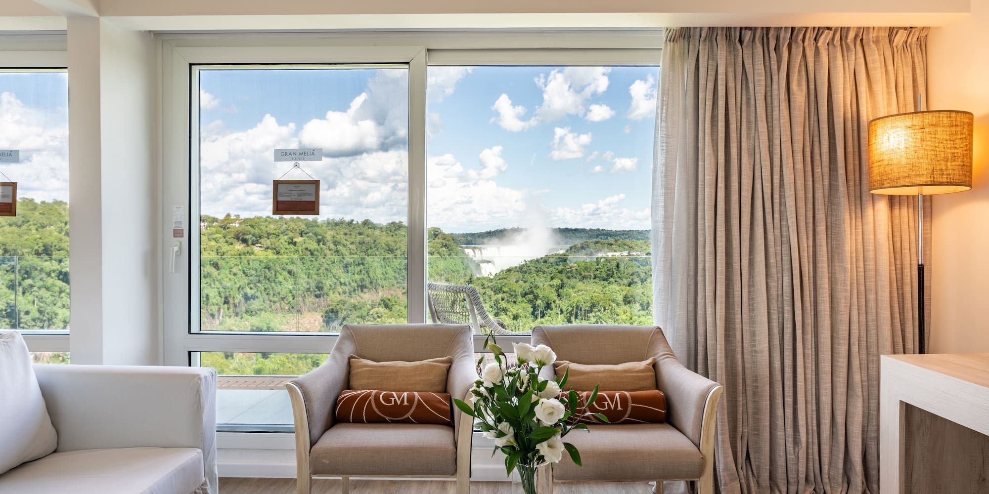 a room with a view of the mountains and trees